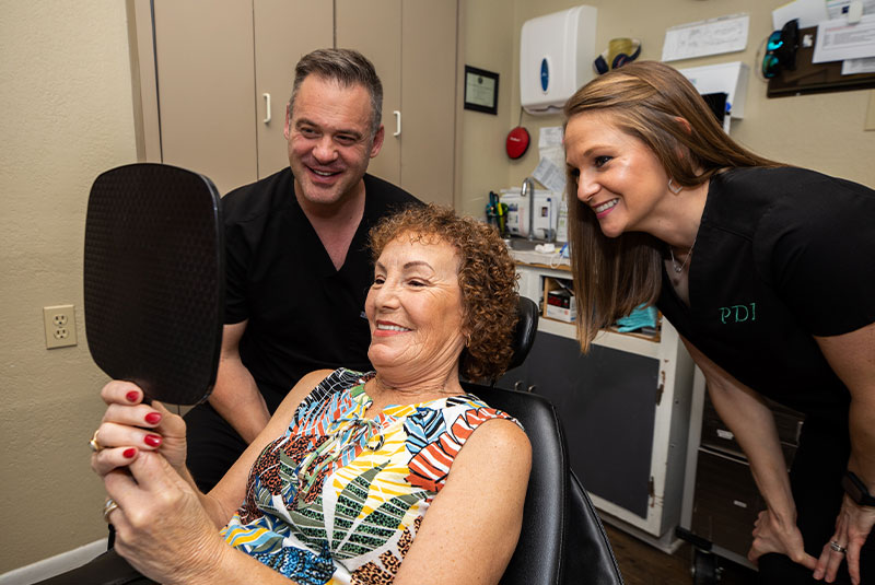 full arch dental patient smiling